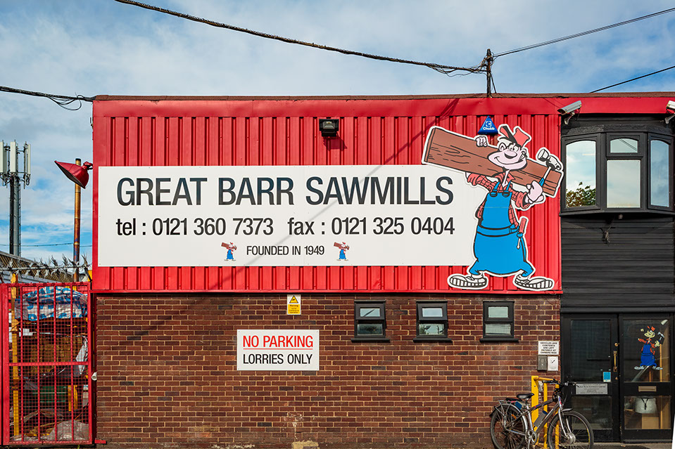 The red-clad Great Barr Sawmills building on Aldridge Road with its large sign