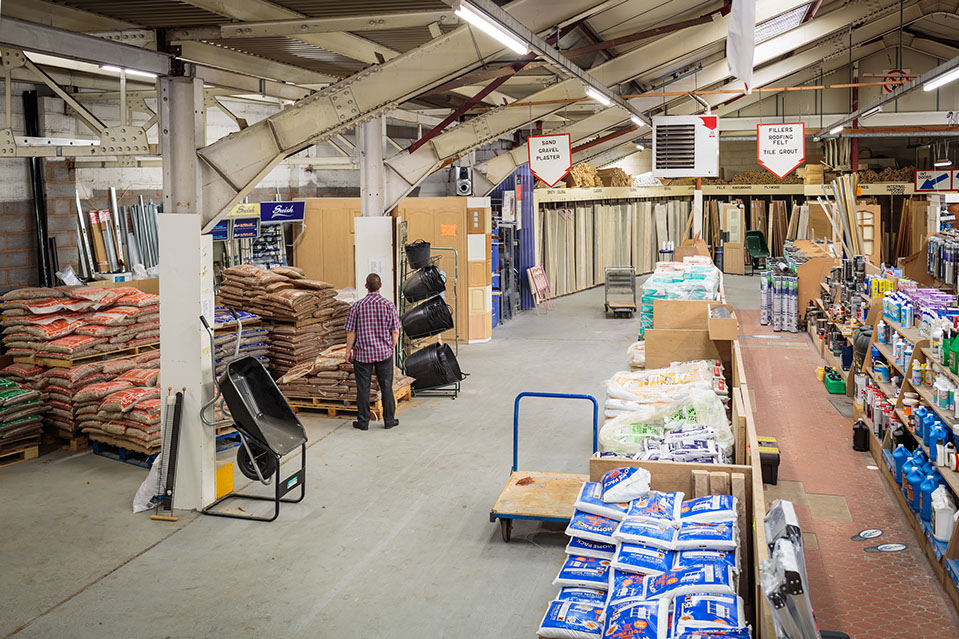 Long aisle of shelving stocked with hardware and building supplies